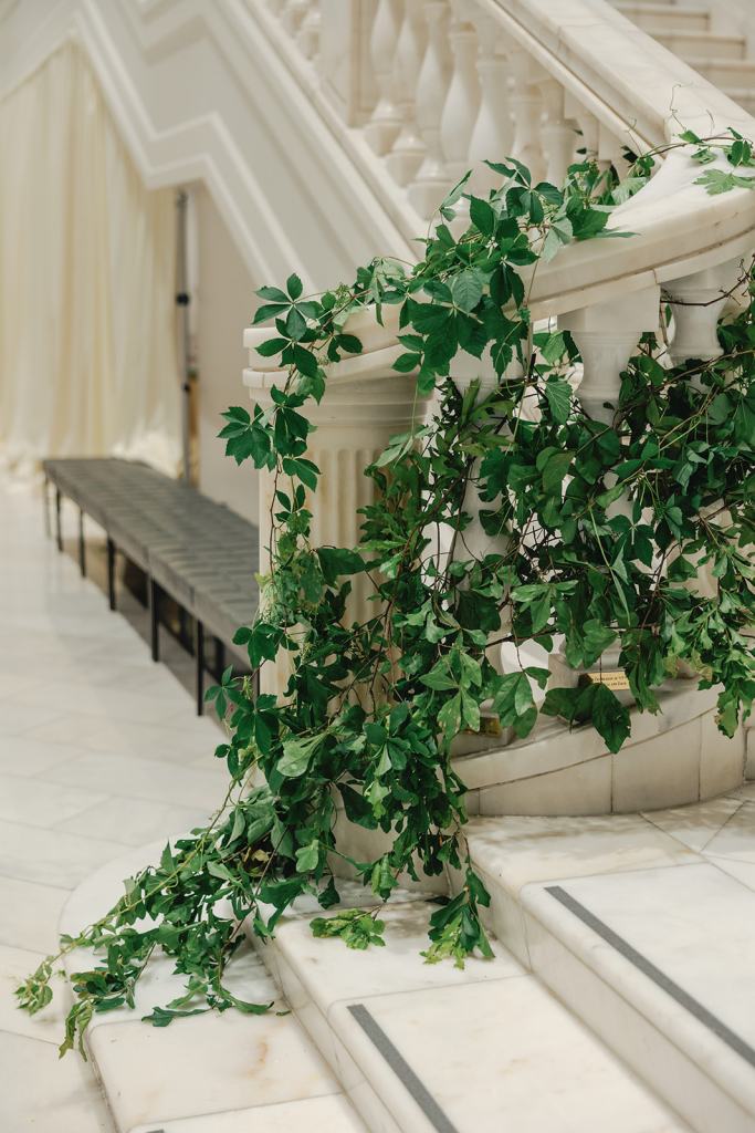 Elegant staircase installation with cascading greenery and florals at a DC wedding