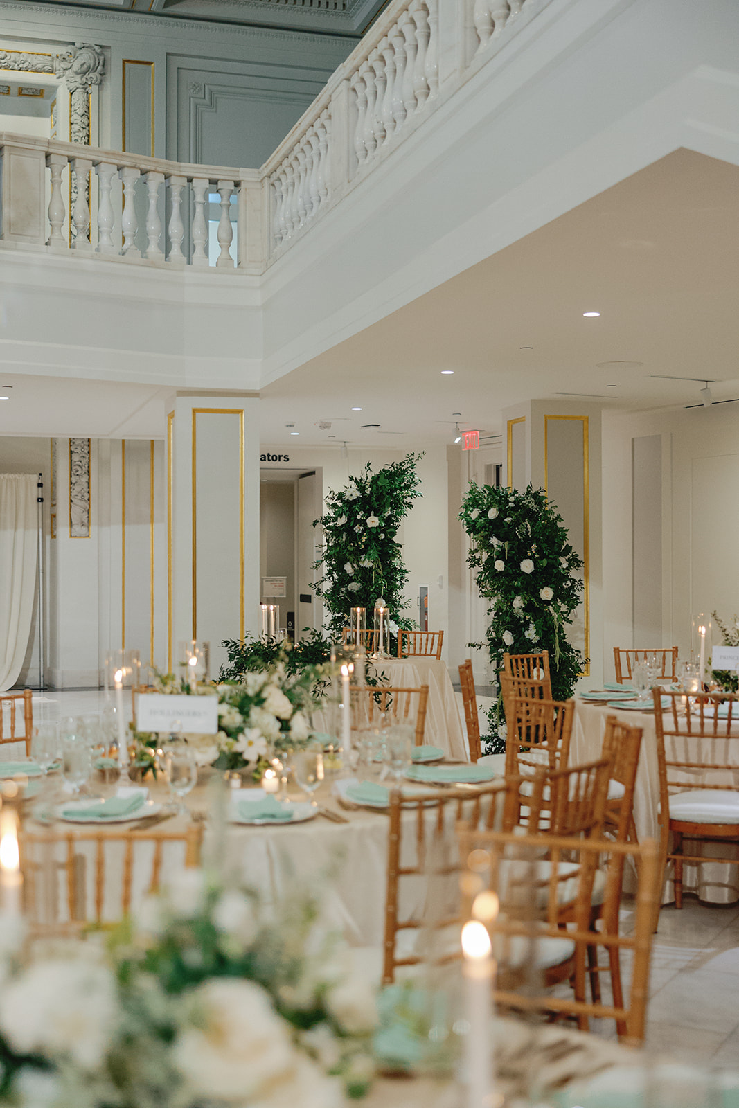Sweetheart table with garden roses, white florals, and candles at a formal museum wedding